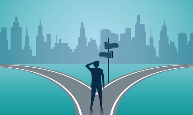 Image of a person standing at a fork in the road